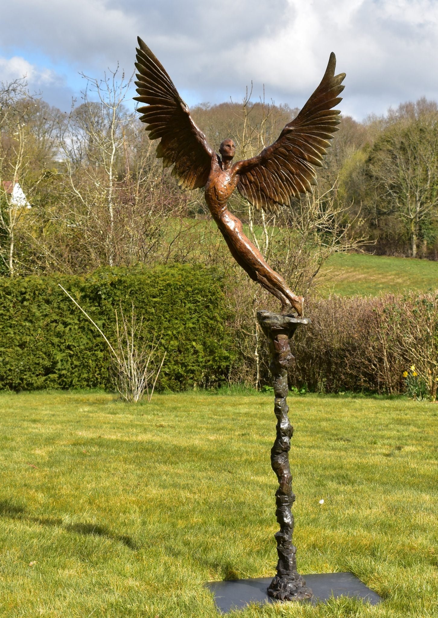 Sculpture in a garden of the mythical figure of Icarus rising towards the sun
