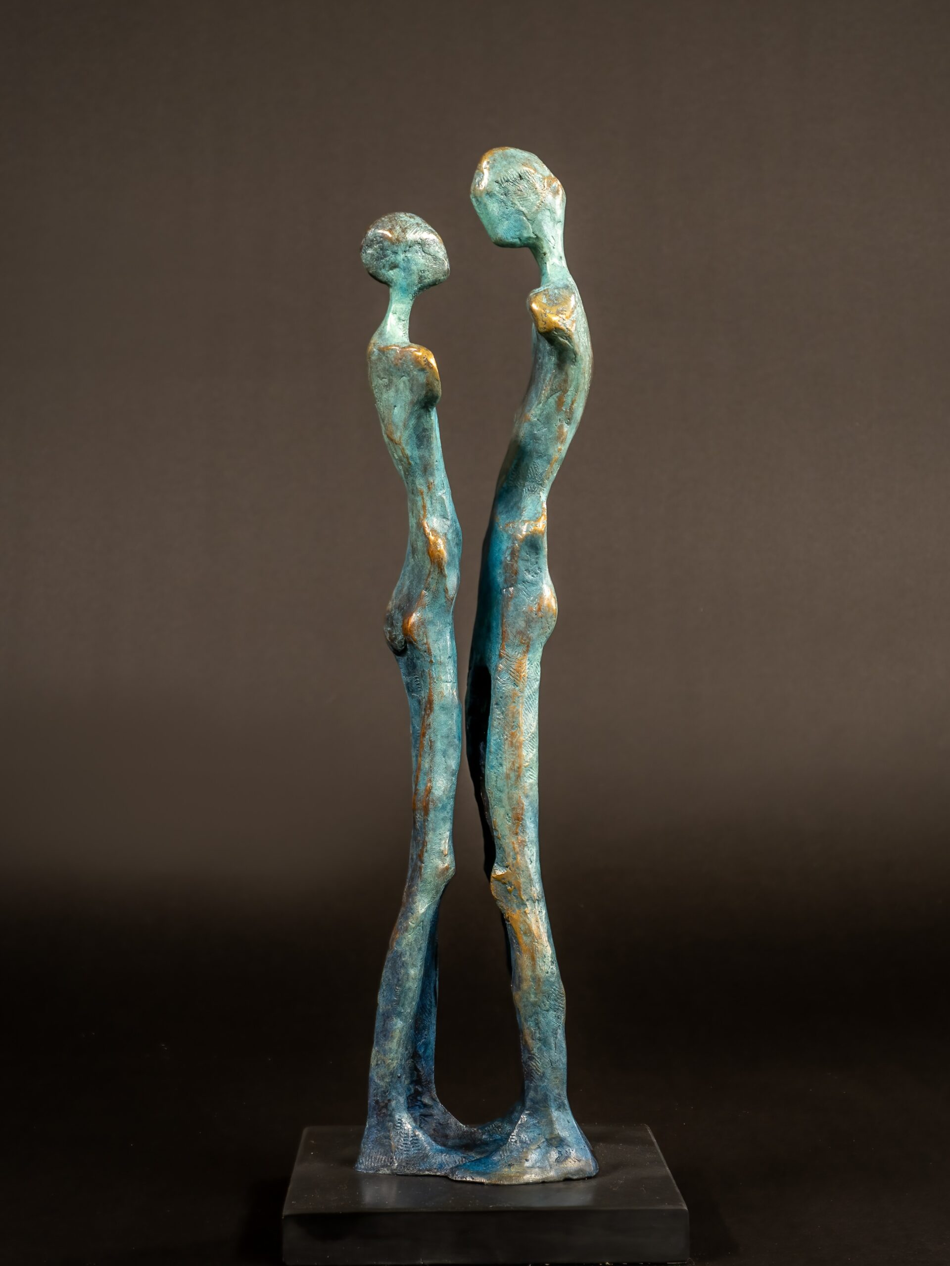 Abstract bronze sculpture of two standing figures with textured finish